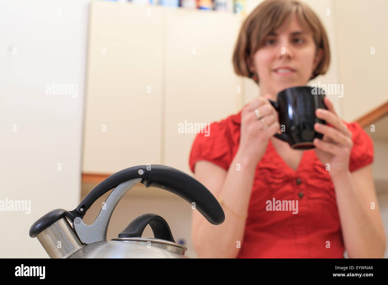 Young blind woman making coffee in her kitchen Stock Photo Alamy