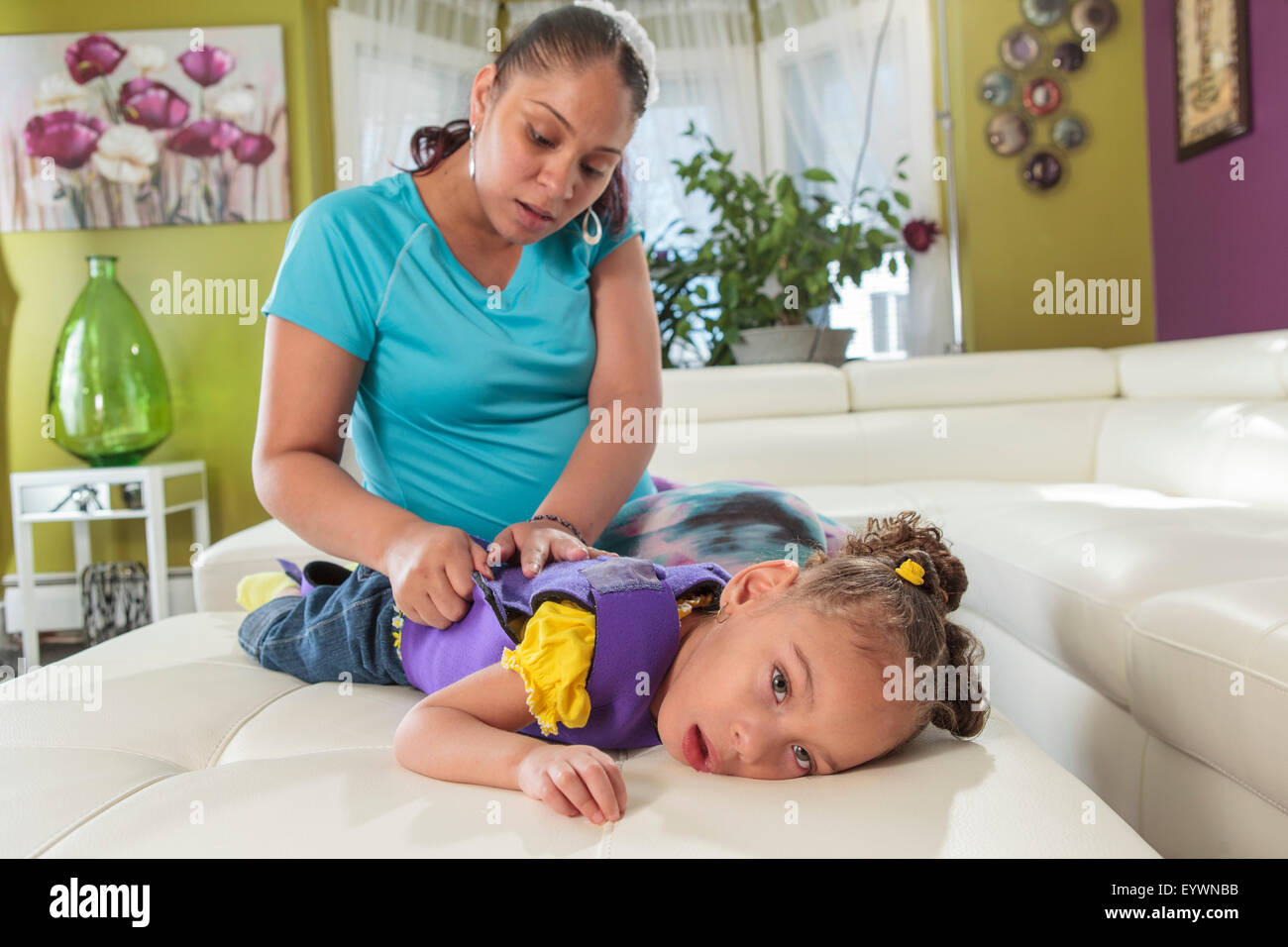 Mother caring for daughter with Cerebral Palsy Stock Photo