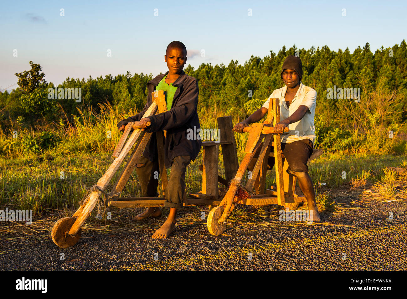 Local boys on their self-made bicycles, Malawi, Africa Stock Photo
