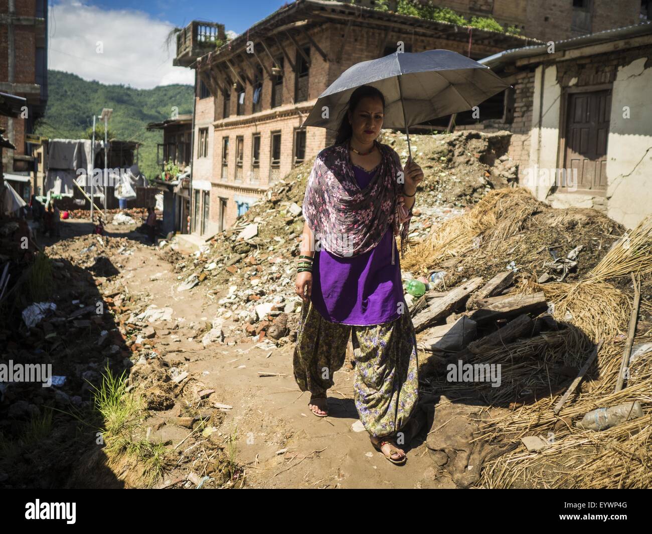 Sankhu, Central Region, Nepal. 3rd Aug, 2015. A woman walks down a street still strewn with debris from the earthquake in Sankhu, a community about 90 minutes from central Kathmandu. The Nepal Earthquake on April 25, 2015, (also known as the Gorkha earthquake) killed more than 9,000 people and injured more than 23,000. It had a magnitude of 7.8.  It was the worst natural disaster to strike Nepal since the 1934 Nepal''“Bihar earthquake. © ZUMA Press, Inc./Alamy Live News Stock Photo