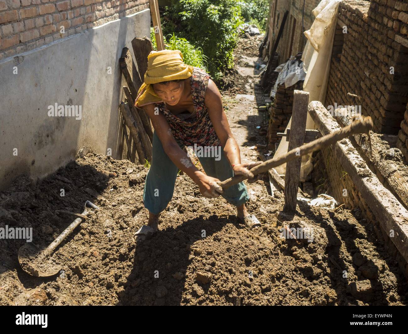 Sankhu, Central Region, Nepal. 3rd Aug, 2015. A woman digs up mud to be used as mortar in the repair of a home destroyed in the earthquake in Sankhu, a community about 90 minutes from central Kathmandu. The Nepal Earthquake on April 25, 2015, (also known as the Gorkha earthquake) killed more than 9,000 people and injured more than 23,000. It had a magnitude of 7.8.  It was the worst natural disaster to strike Nepal since the 1934 Nepal''“Bihar earthquake. © ZUMA Press, Inc./Alamy Live News Stock Photo