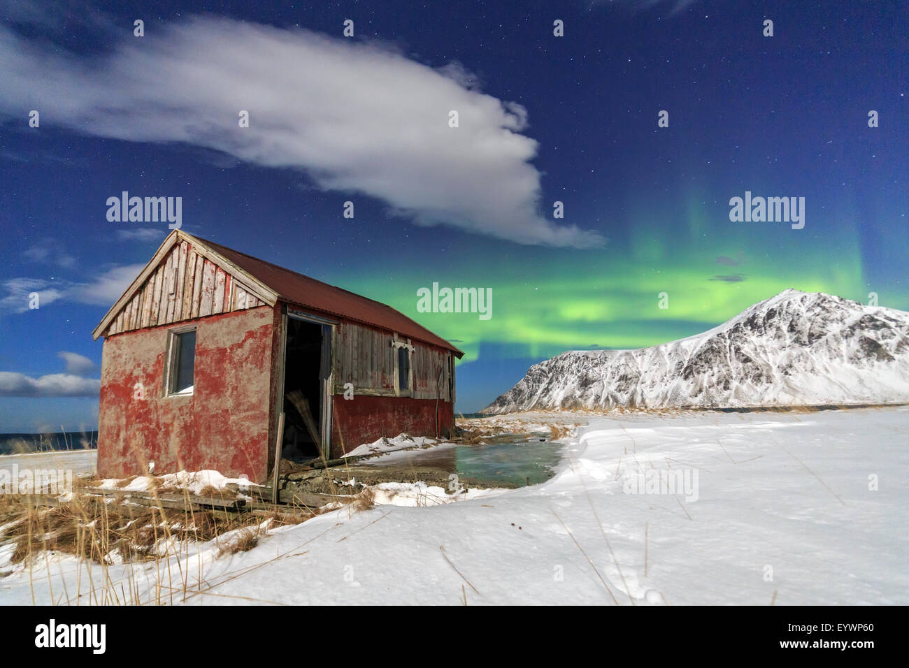 Northern Lights Aurora Borealis Over An Abandoned Log Cabin