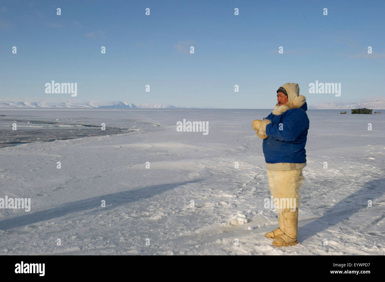 Inuit/Inughuit subsistence hunter in traditional clothing for winter and spring of seal skin boots (Kamiks), Greenland, Denmark Stock Photo