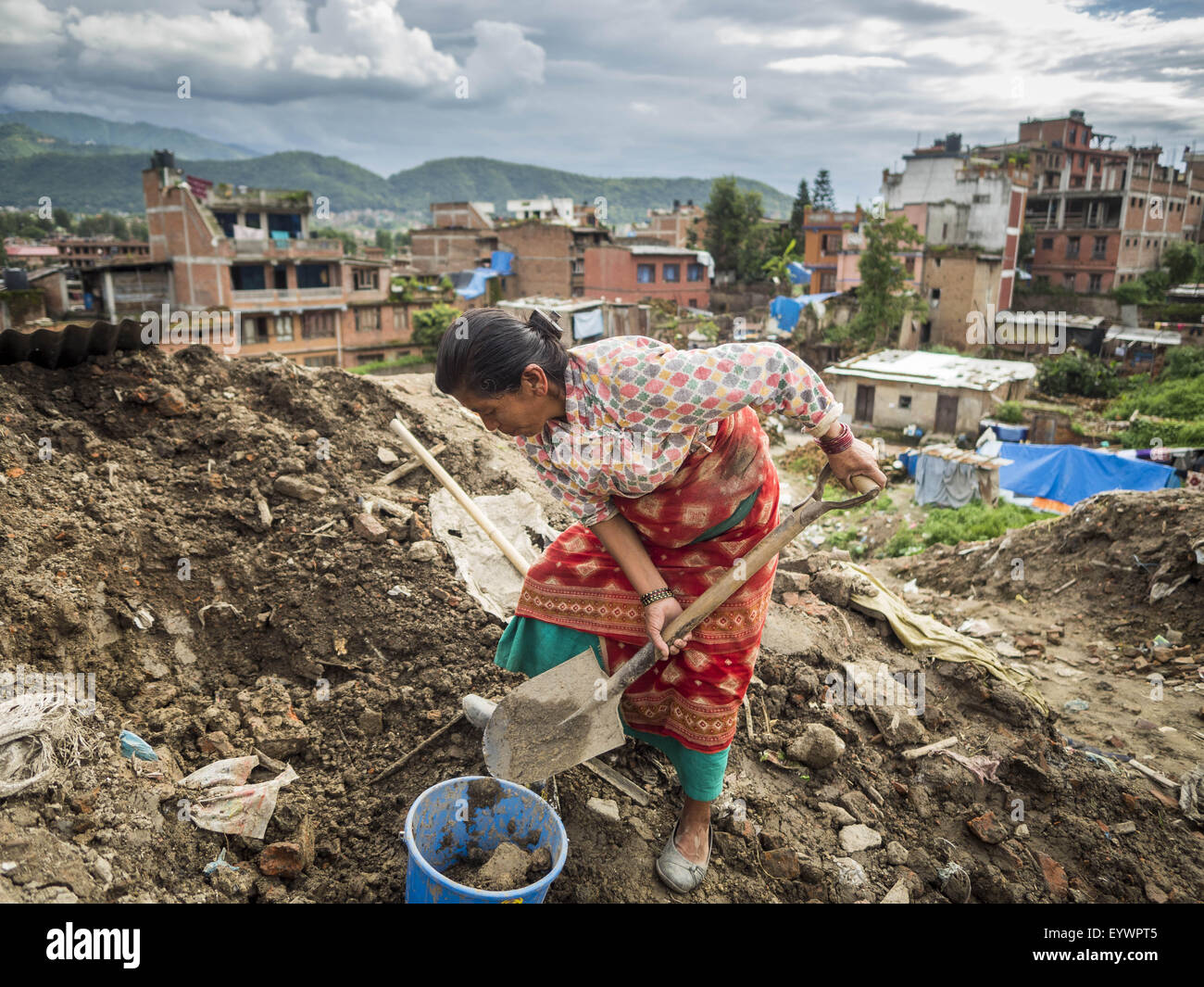 Bhaktapur, Central Region, Nepal. 2nd Aug, 2015. A woman digs up dirt for her temporary shelter in a small Internal Displaced Person (IDP) camp in Bhaktapur. Bhaktapur was badly damaged in the earthquake the hit Nepal in April 2015. The Nepal Earthquake on April 25, 2015, (also known as the Gorkha earthquake) killed more than 9,000 people and injured more than 23,000. It had a magnitude of 7.8. © ZUMA Press, Inc./Alamy Live News Stock Photo