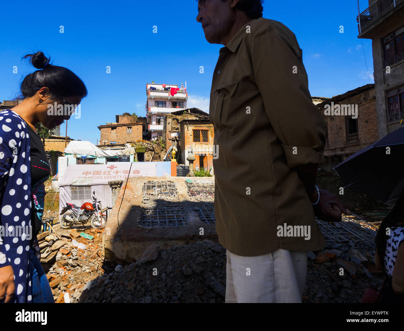 Sankhu, Central Region, Nepal. 3rd Aug, 2015. People walk past a Hindu temple destroyed in the Nepal earthquake in Sankhu, a community about 90 minutes from central Kathmandu. The Nepal Earthquake on April 25, 2015, (also known as the Gorkha earthquake) killed more than 9,000 people and injured more than 23,000. It had a magnitude of 7.8.  It was the worst natural disaster to strike Nepal since the 1934 Nepal''“Bihar earthquake. © ZUMA Press, Inc./Alamy Live News Stock Photo