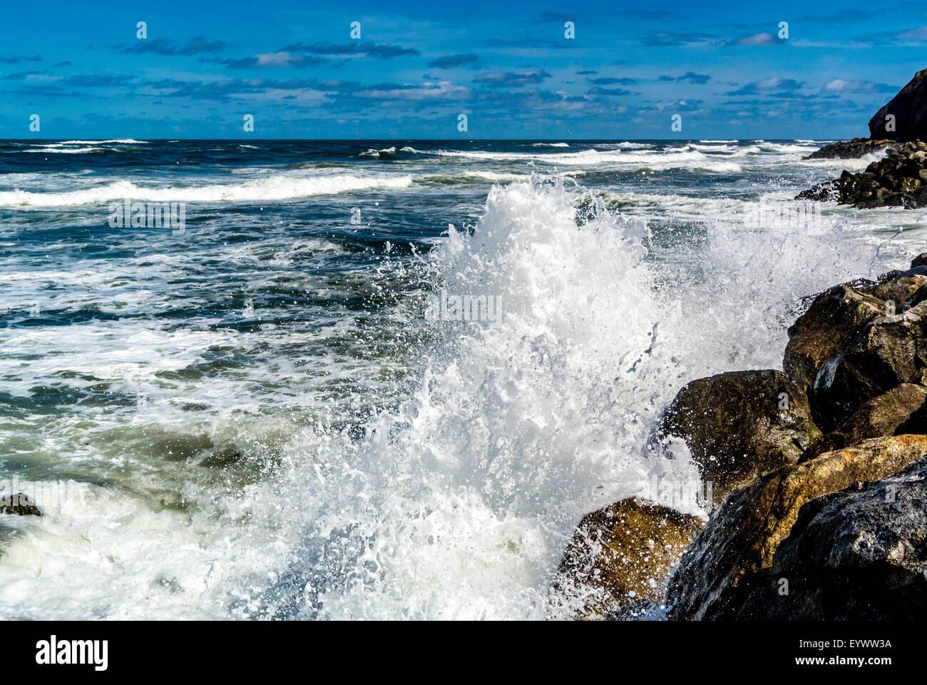 Ocean waves breaking onto rocks. Whitby. Stock Photo