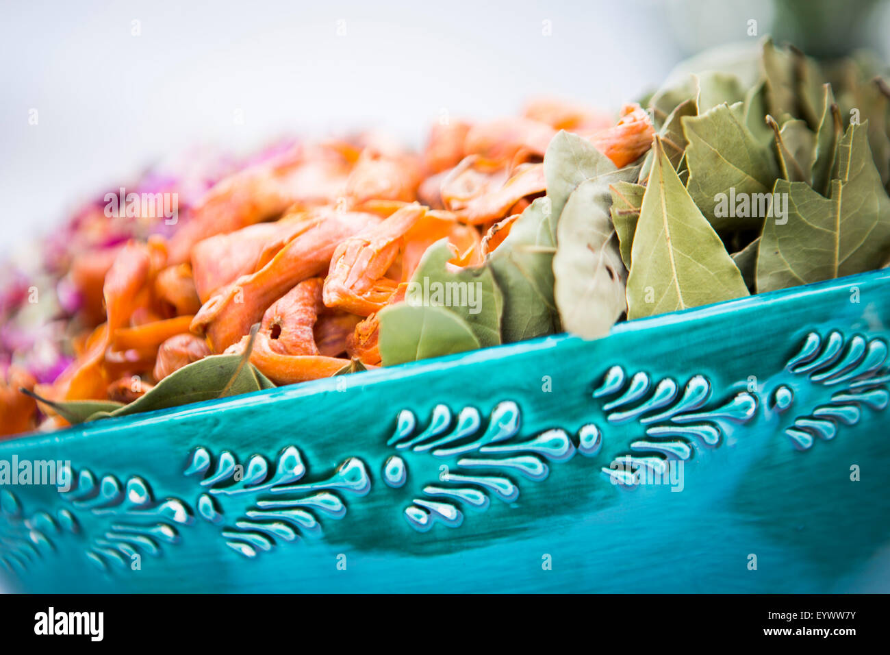 A bowl of spices and herbs used in Indian cookery including bay leaf rose petals and mace. Stock Photo