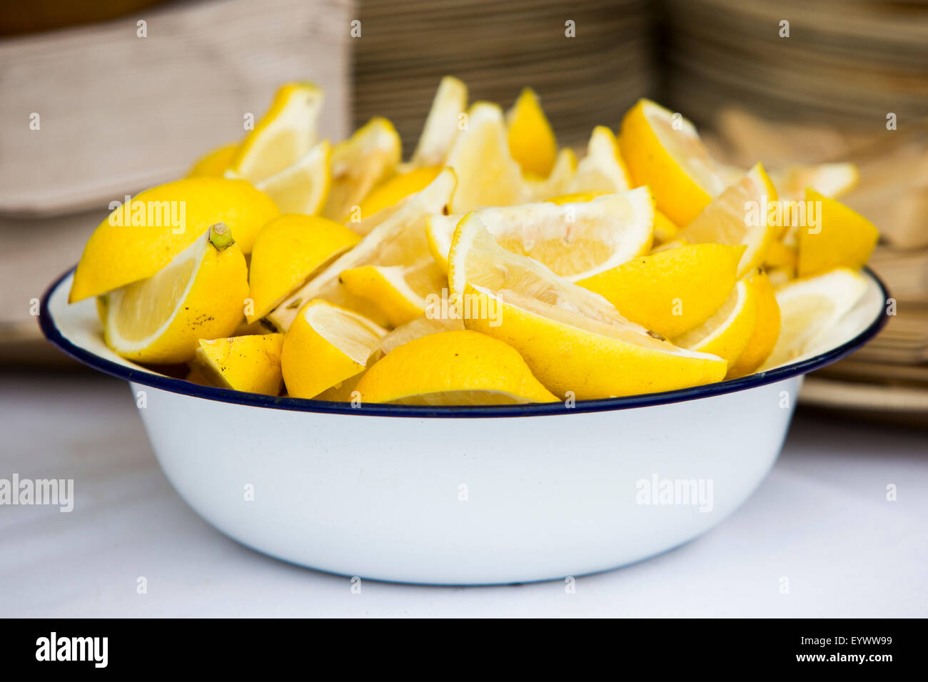 Sliced lemons in blue rimmed white bowl. Stock Photo