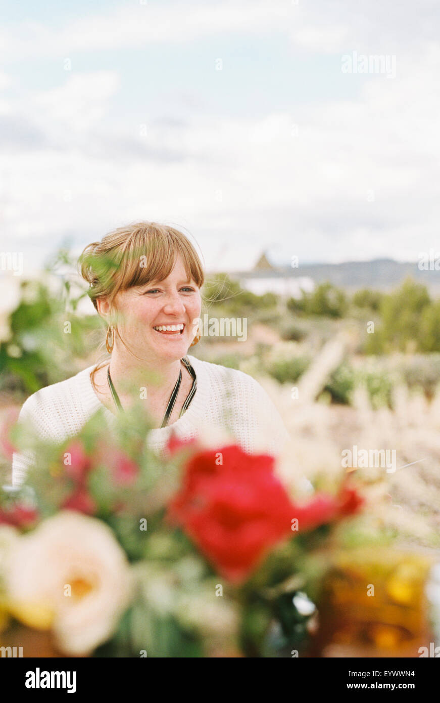 Smiling woman enjoying an outdoor meal in a desert. Stock Photo