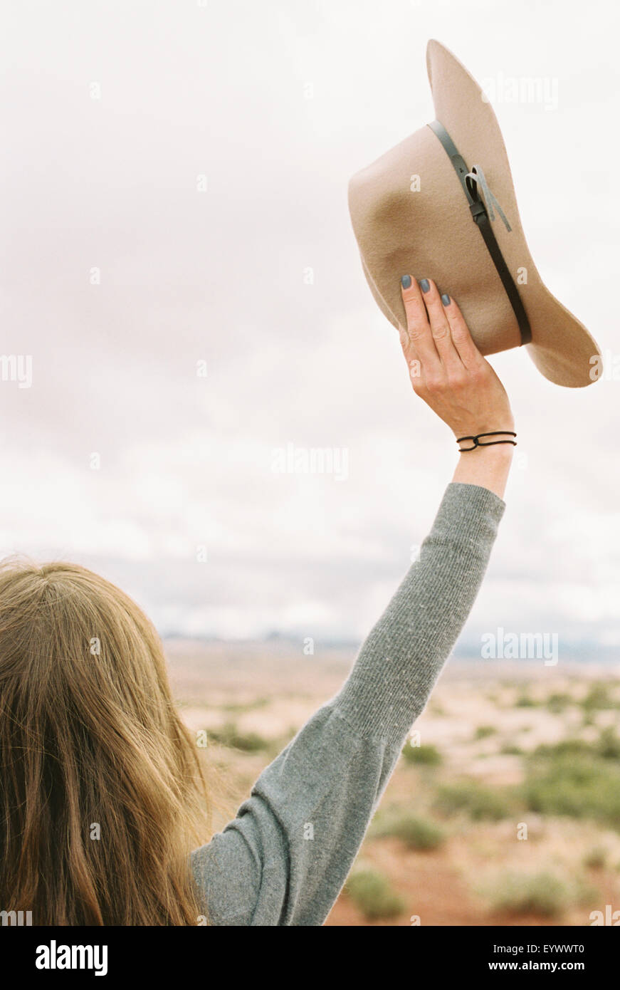 woman standing her arms raised up in the air. Stock Photo