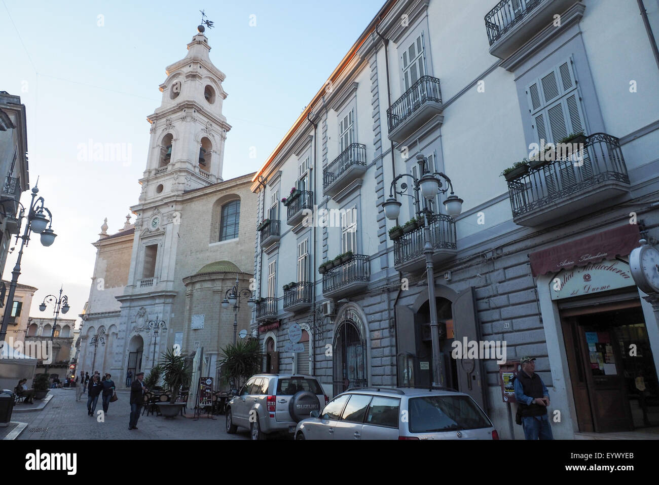 People going on their evening walk in Foggia with the Church of Our Lady of the Assumption in the background. Stock Photo