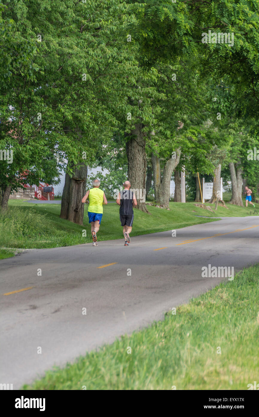 Senior men running on a rural road  for exercise Stock Photo