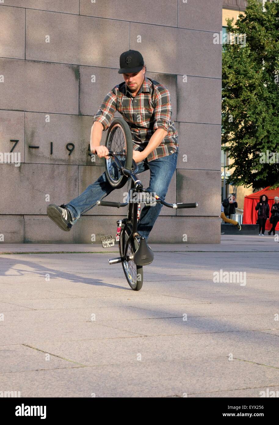 Rider showing tricks on a BMX bike at the Night of the Arts festival Stock Photo