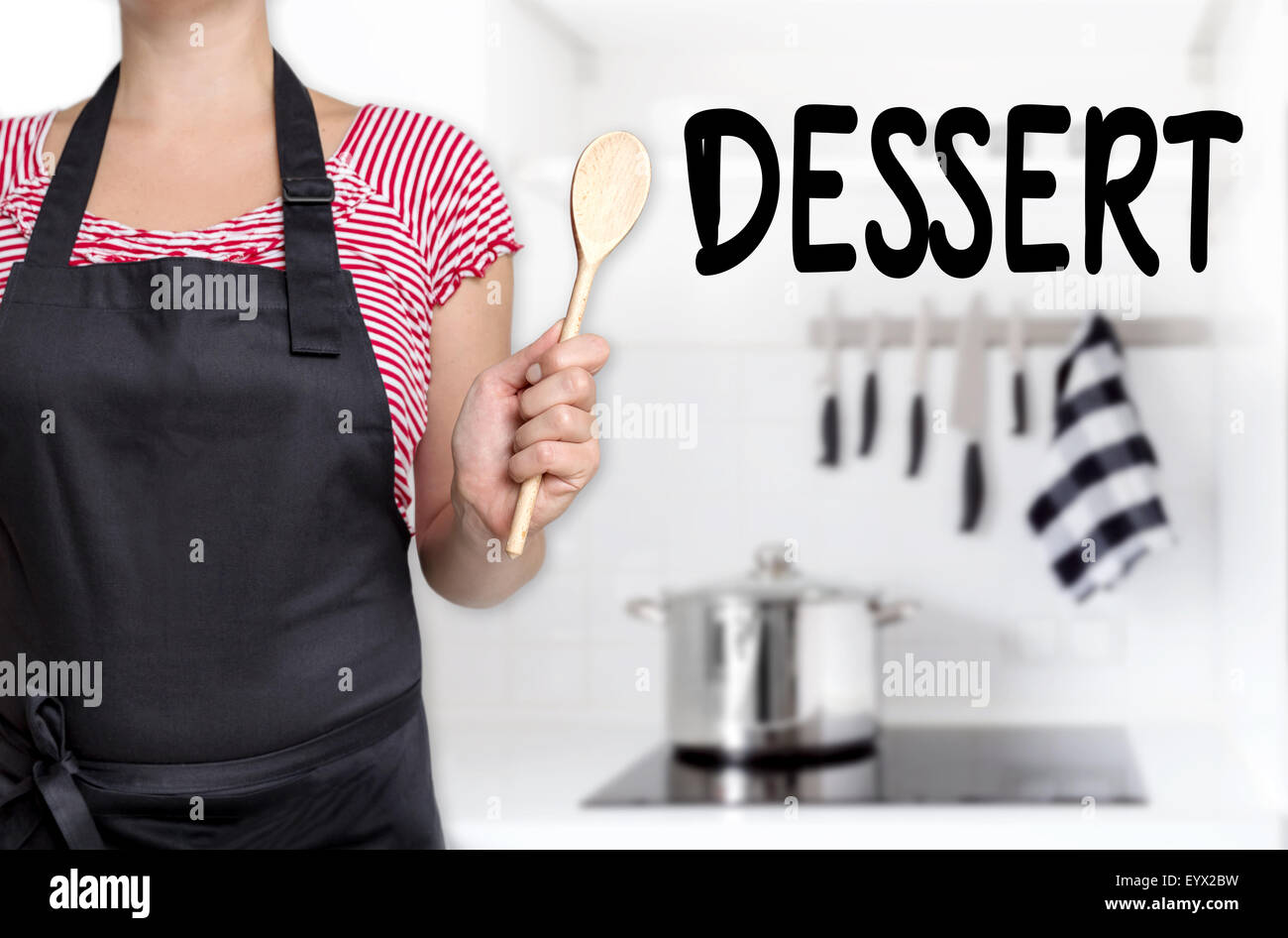 dessert cook holding wooden spoon background. Stock Photo