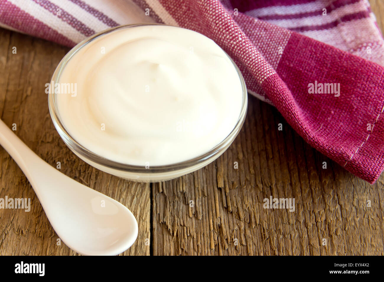 Sour cream (white sauce) with dill on wooden table, horizontal close up Stock Photo