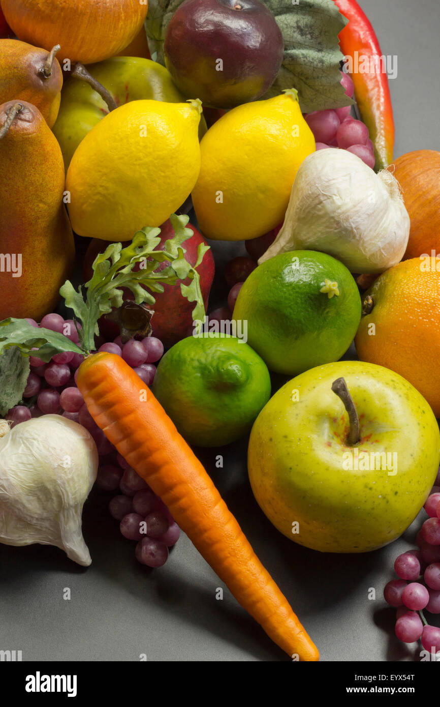 Assorted pile of different colorful fake fruits and vegetables Stock