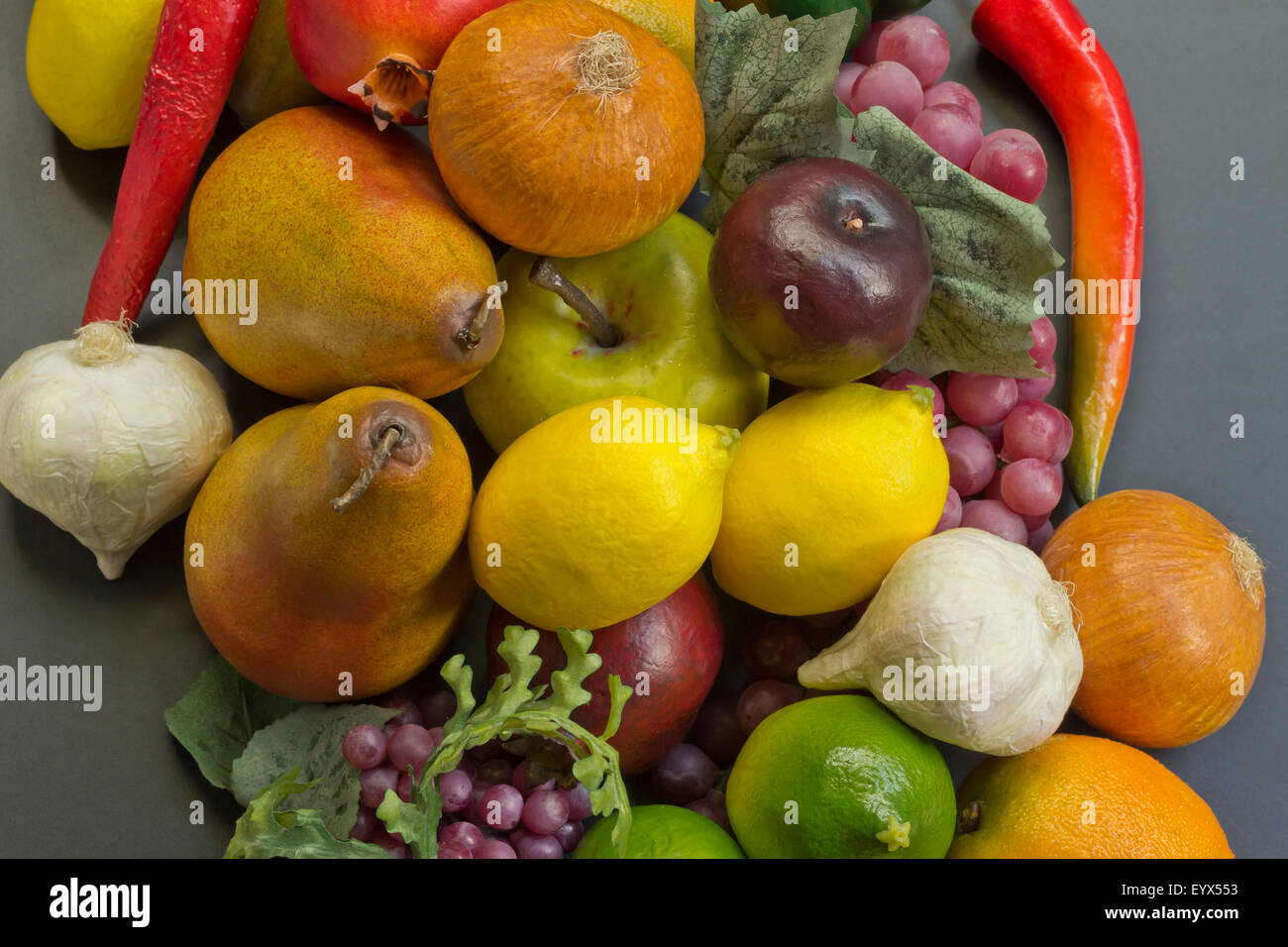 Assorted pile of different colorful fake fruits and vegetables Stock