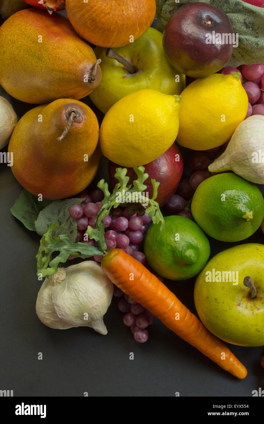Assorted pile of different colorful fake fruits and vegetables Stock