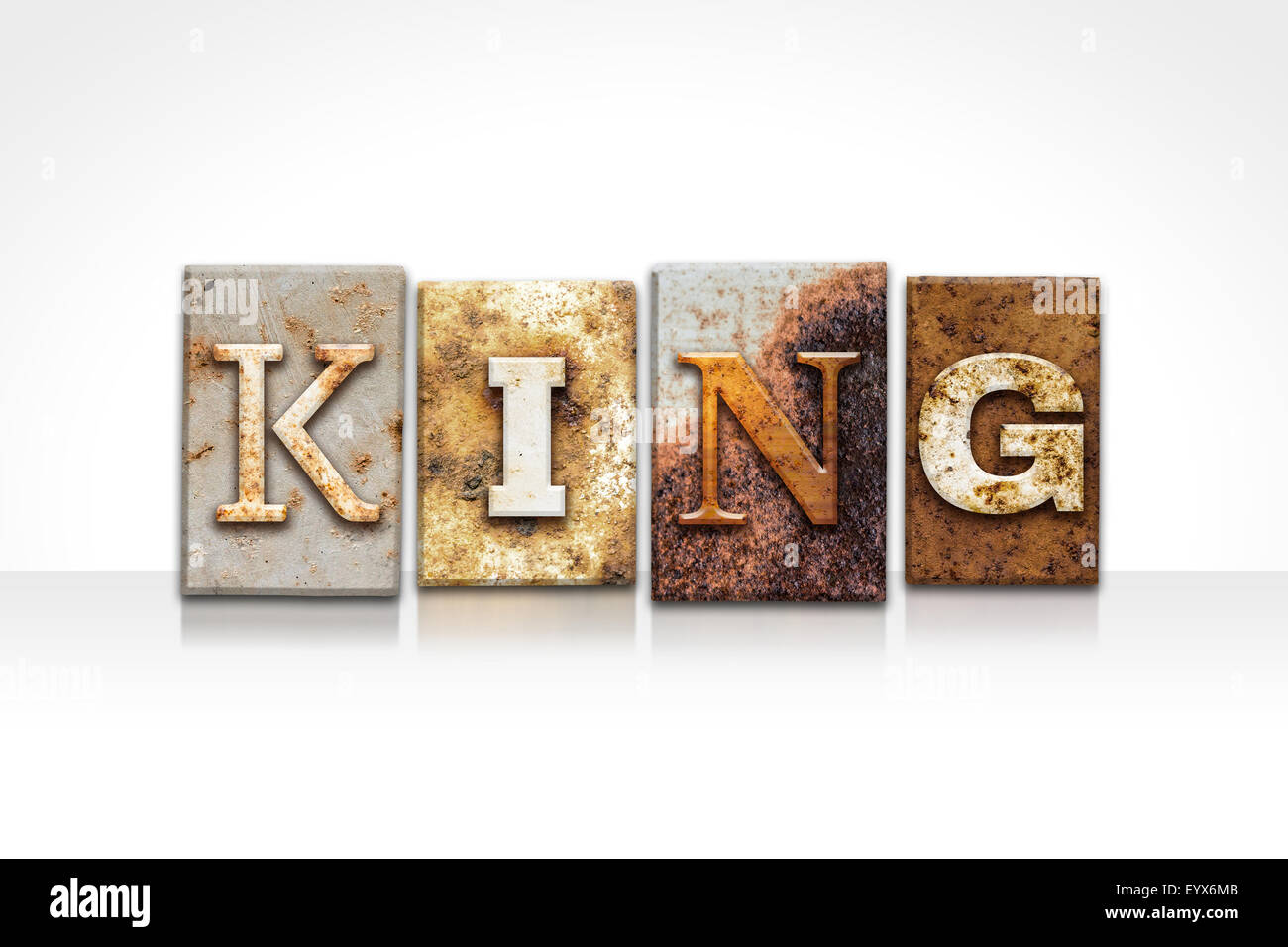The word "KING" written in rusty metal letterpress type isolated on a