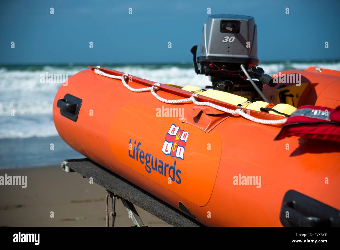 Surf lifesaving, warning flags and equipment on beach ready for use by RNLI lifeguards Stock