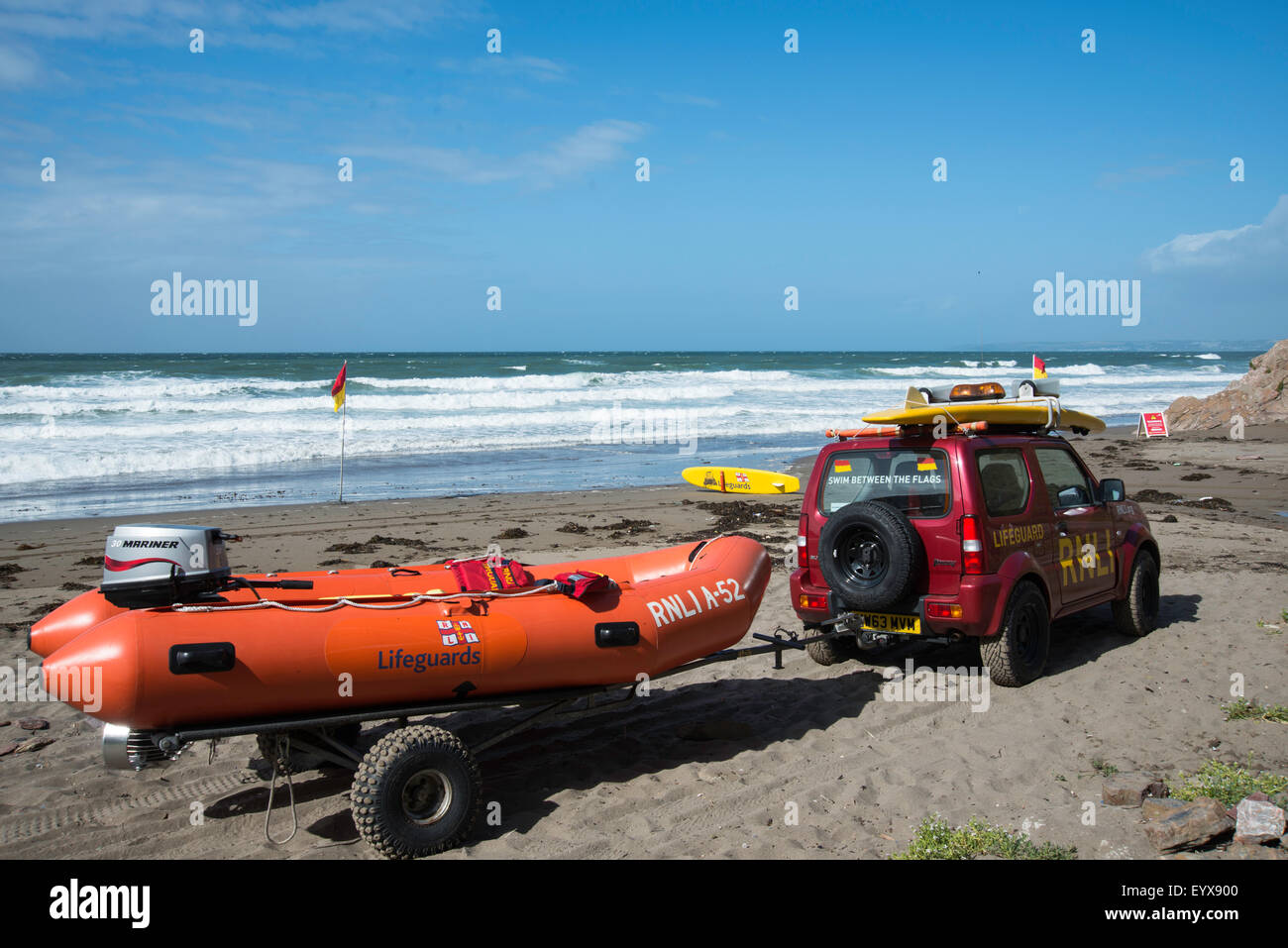 Surf lifesaving, warning flags and equipment on beach ready for use by RNLI lifeguards Stock