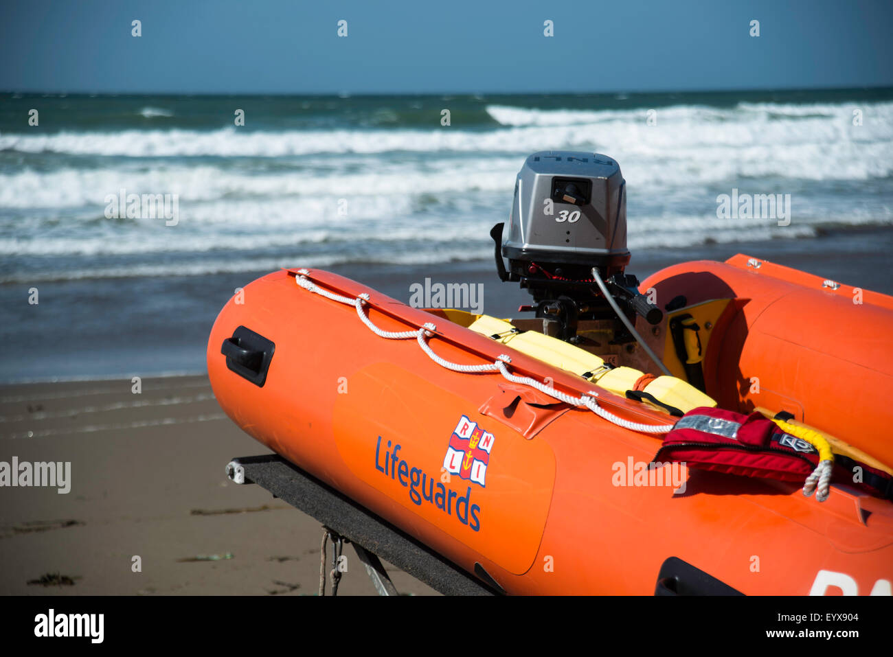 Surf lifesaving, warning flags and equipment on beach ready for use by RNLI lifeguards Stock