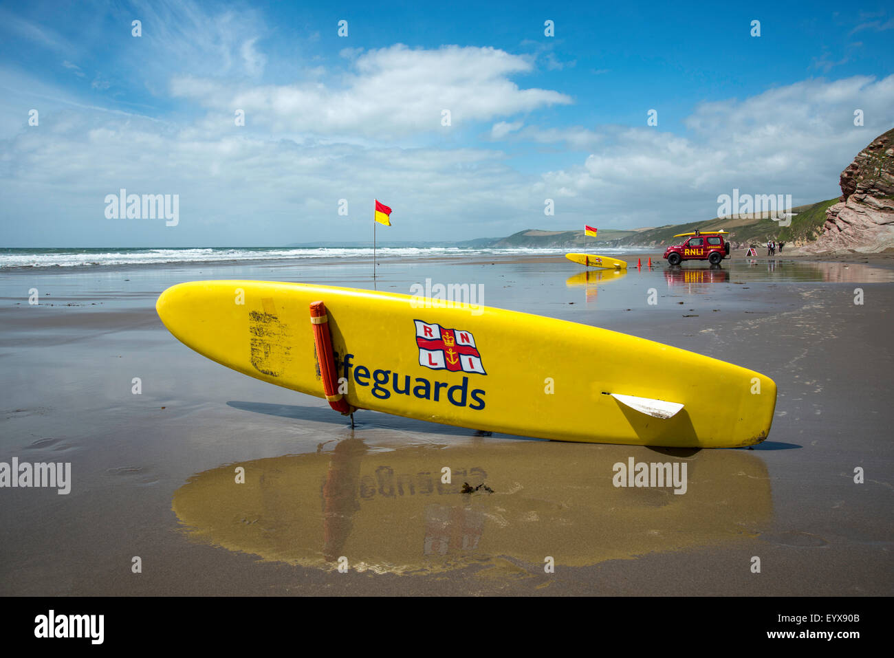 Surf lifesaving, warning flags and equipment on beach ready for use by RNLI lifeguards Stock