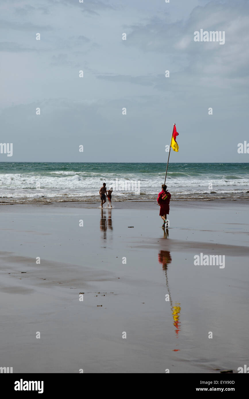 Surf lifesaving, warning flags and equipment on beach ready for use by RNLI lifeguards Stock