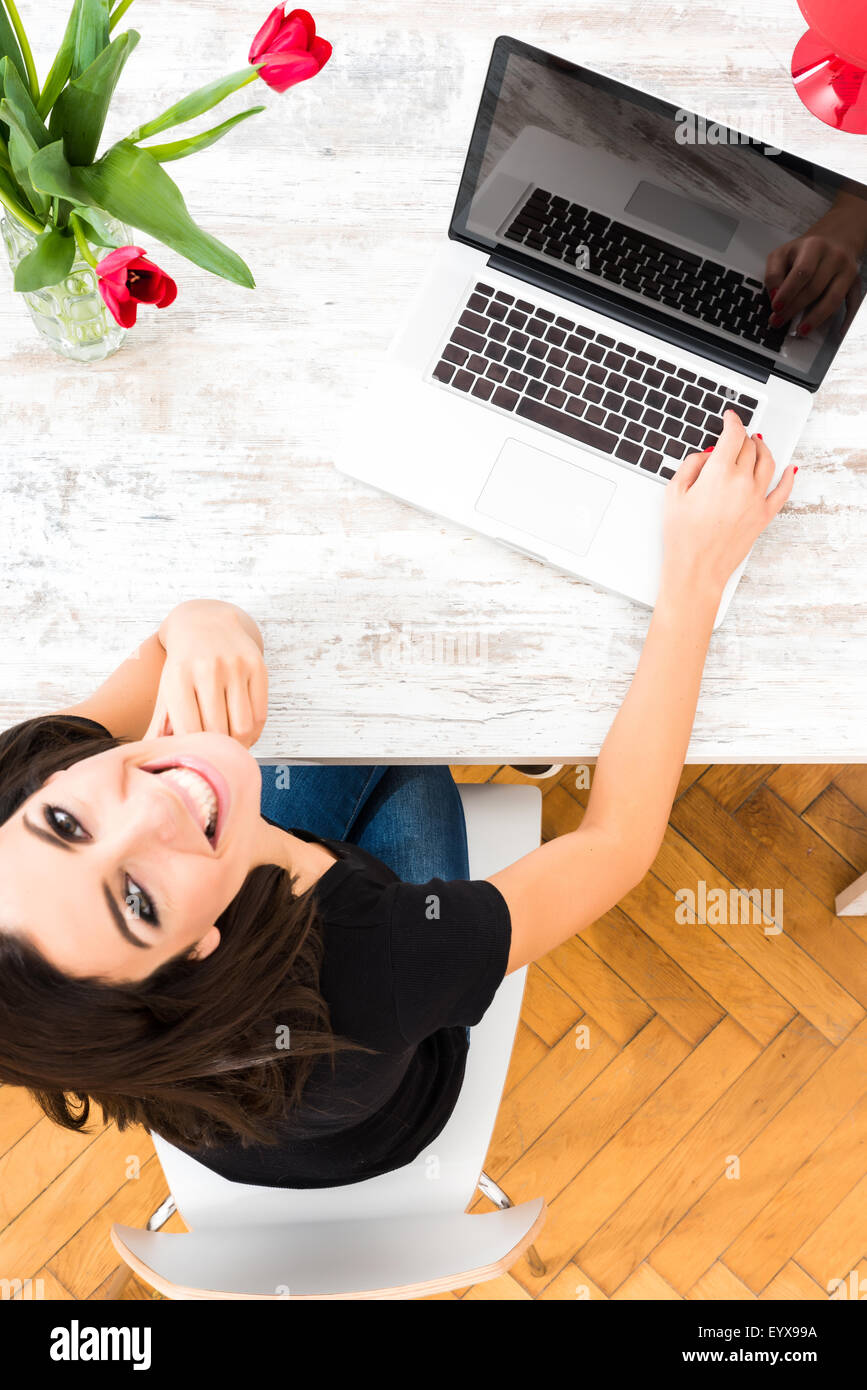 A young beautiful woman using a Laptop computer at home Stock Photo - Alamy