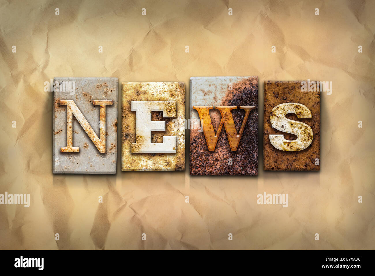 The word "NEWS" written in rusty metal letterpress type on a crumbled aged paper background. Stock Photo