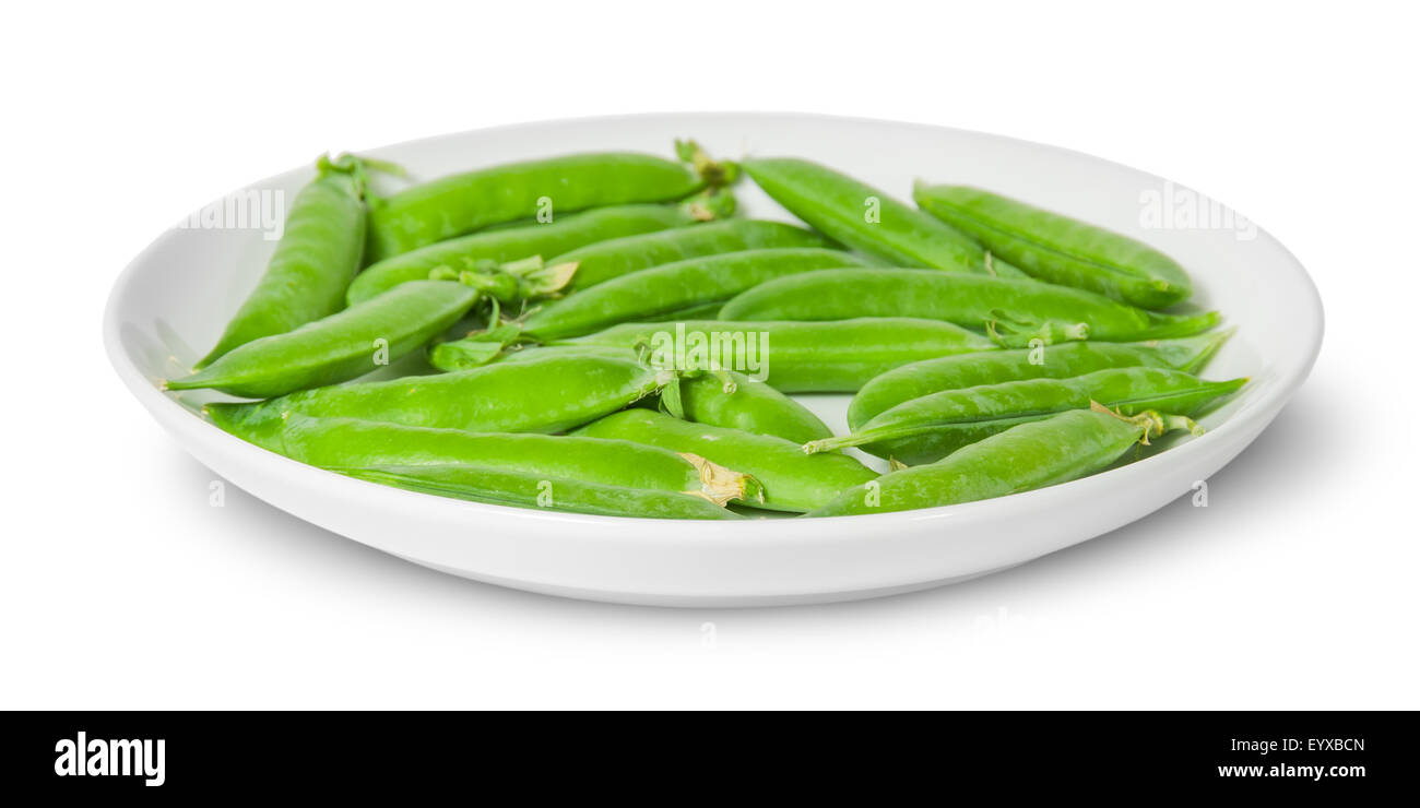 In front several pods of peas on a white plate isolated on white background Stock Photo