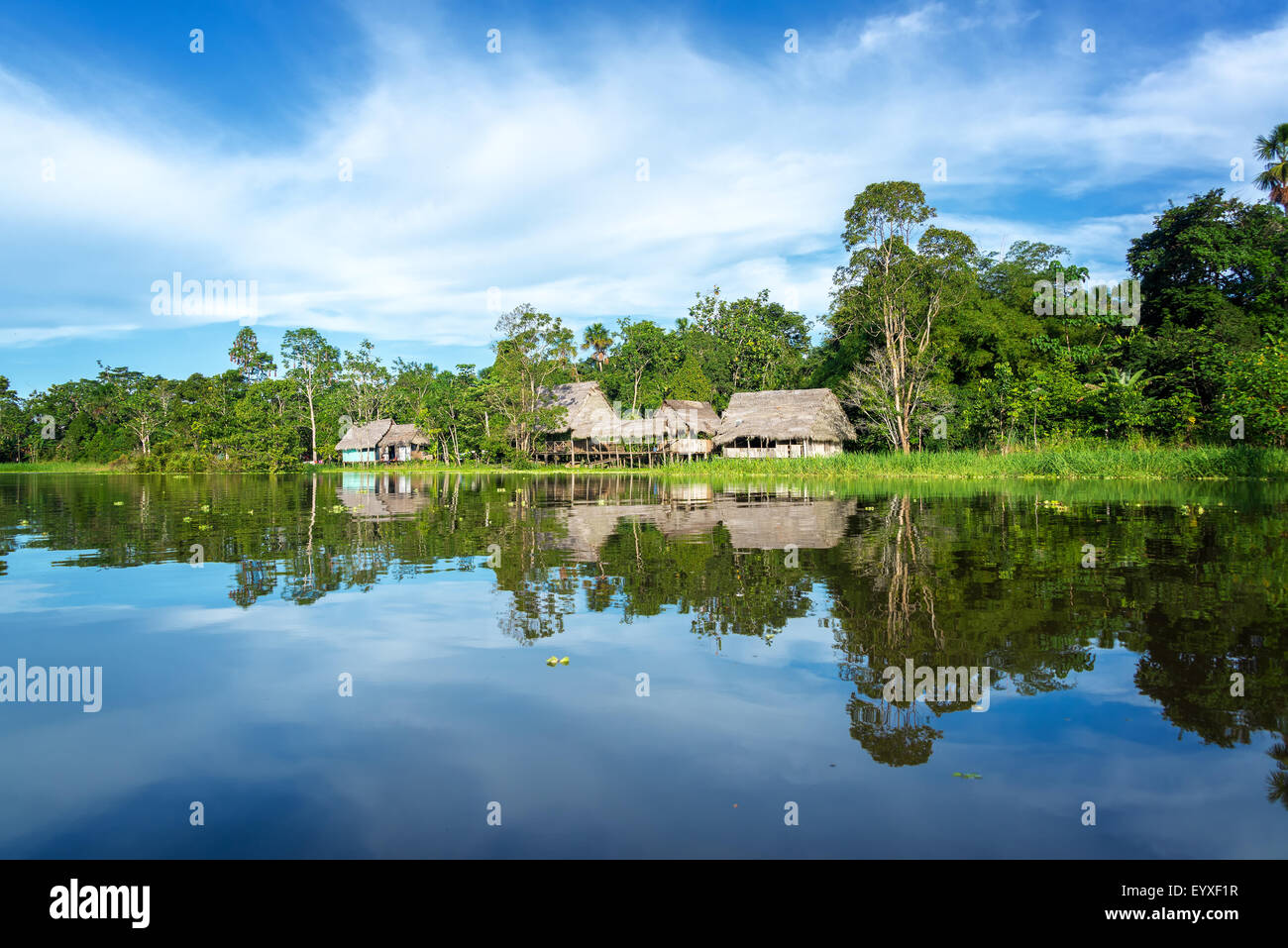 Small town in the Amazon rain forest reflected in the Yanayacu River