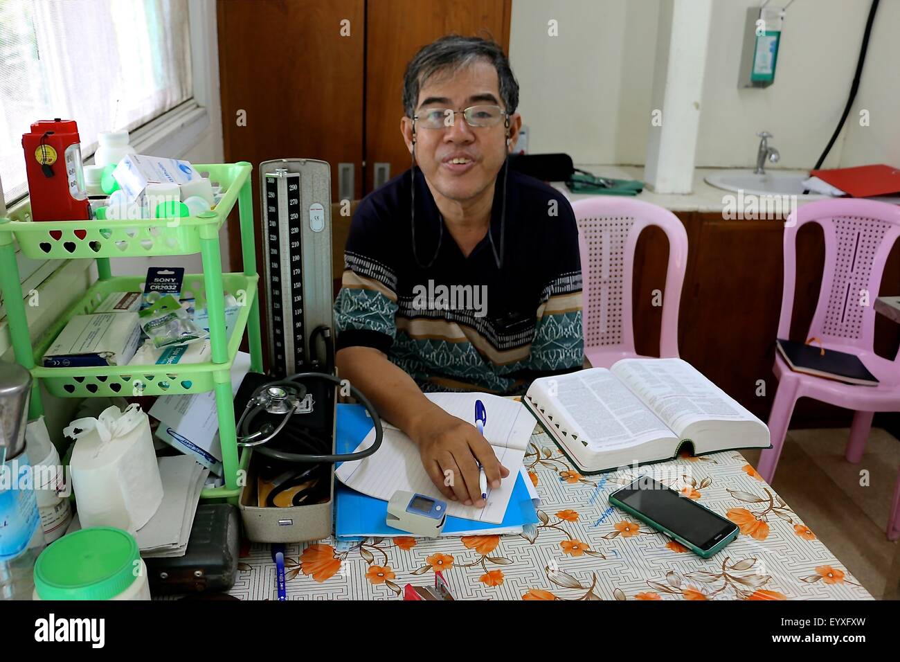 Doctor Chit Pe photographed during a quiet moment aboard the doctor's ship in the Irrawaddy-Delta in Myanmar, 17 June 2015. There is much need for medical facilities in Myanmar following flooding. After cyclone Nargis, German money has funded a doctor's ship there. PHOTO: VERENA HOELZL/DPA Stock Photo