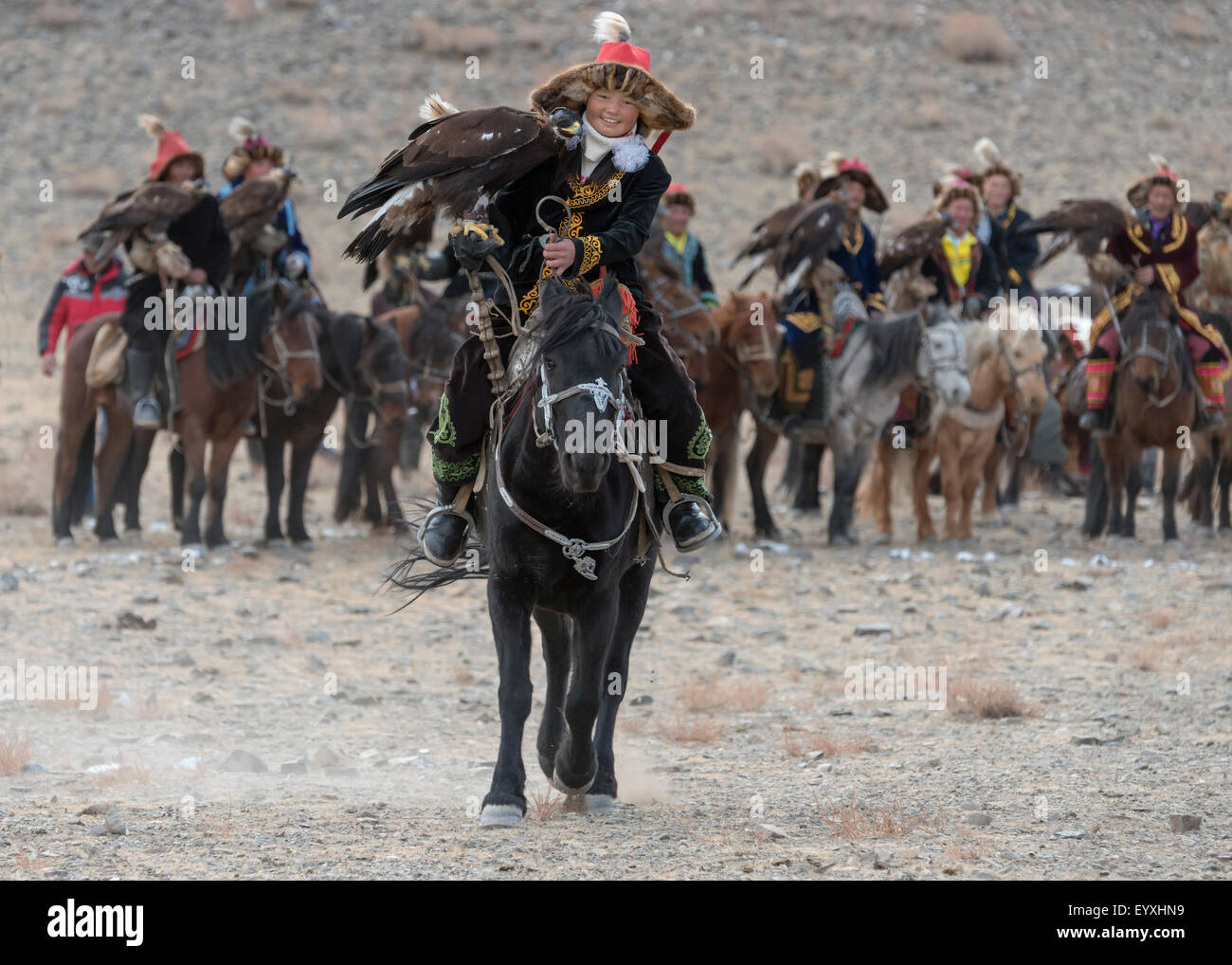 Young girl eagle hunter Ashol Pan riding over to the judges, Eagle