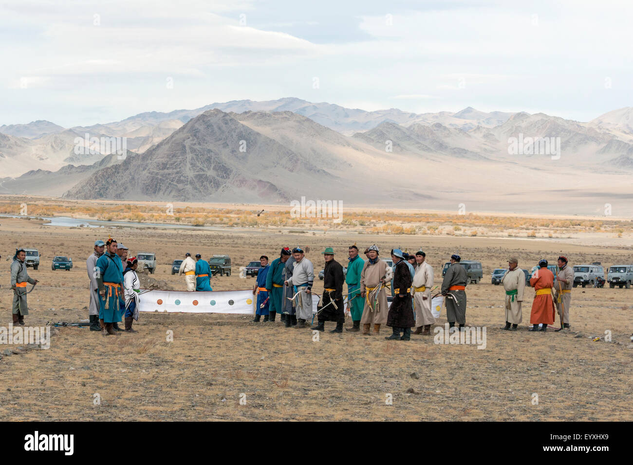 Competitors watching an arrow fly towards the target, archery competition, Eagle Festival, Olgii, Western Mongolia Stock Photo