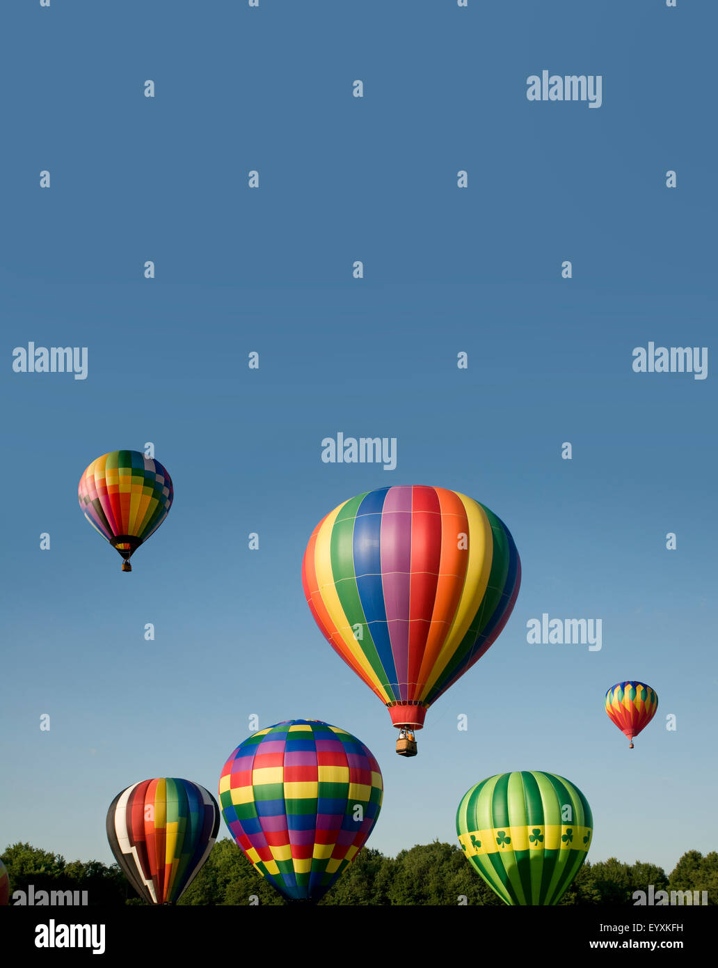 Various hot-air balloons with colorful envelopes ascending or launching at a ballooning festival Stock Photo