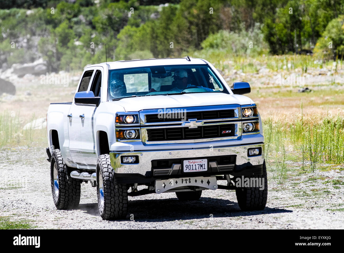 A 2014 Chevy Silverado z71 four wheel drive truck with custom raised suspension, tires, and wheels at Grant Lake in June Lake CA Stock Photo