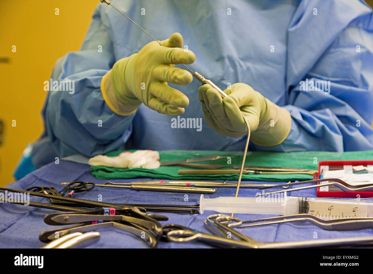 Englewood, Colorado - A nurse prepares tools during lumbar spine surgery at Swedish Medical Center. Stock Photo