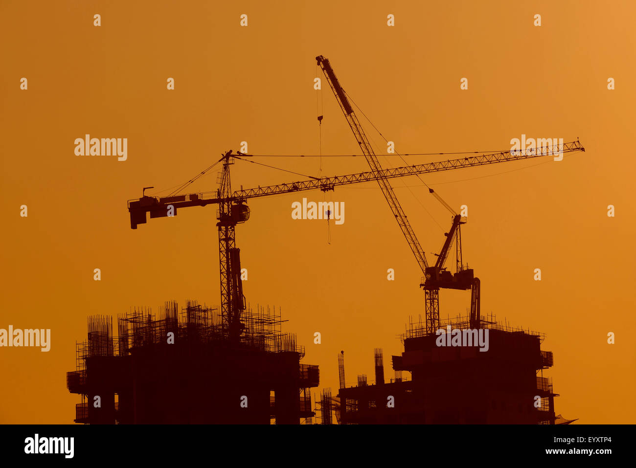 Silhouette of Tower Crane at Construction Site Stock Photo