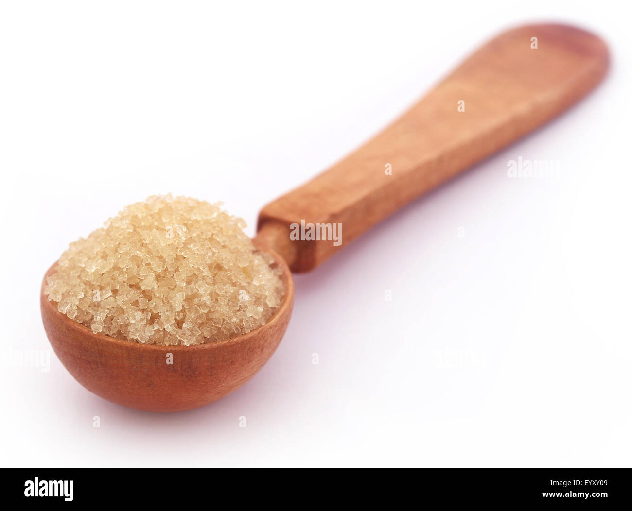 Red sugar in a wooden spoon over white background Stock Photo