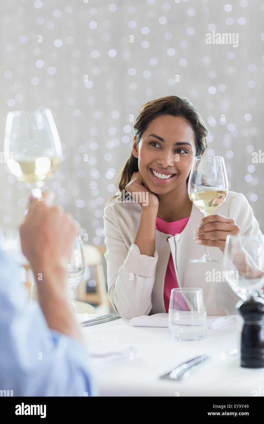 Couple drinking white wine at restaurant table Stock Photo Alamy