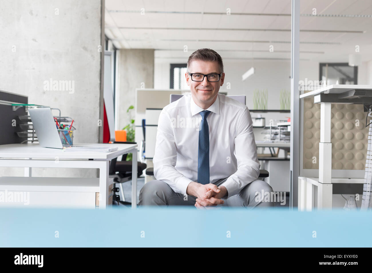 Portrait confident businessman with eyeglasses in office Stock Photo