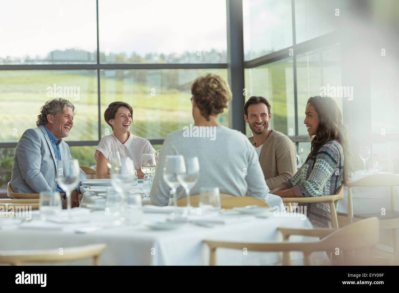 Friends at winery dining room table Stock Photo