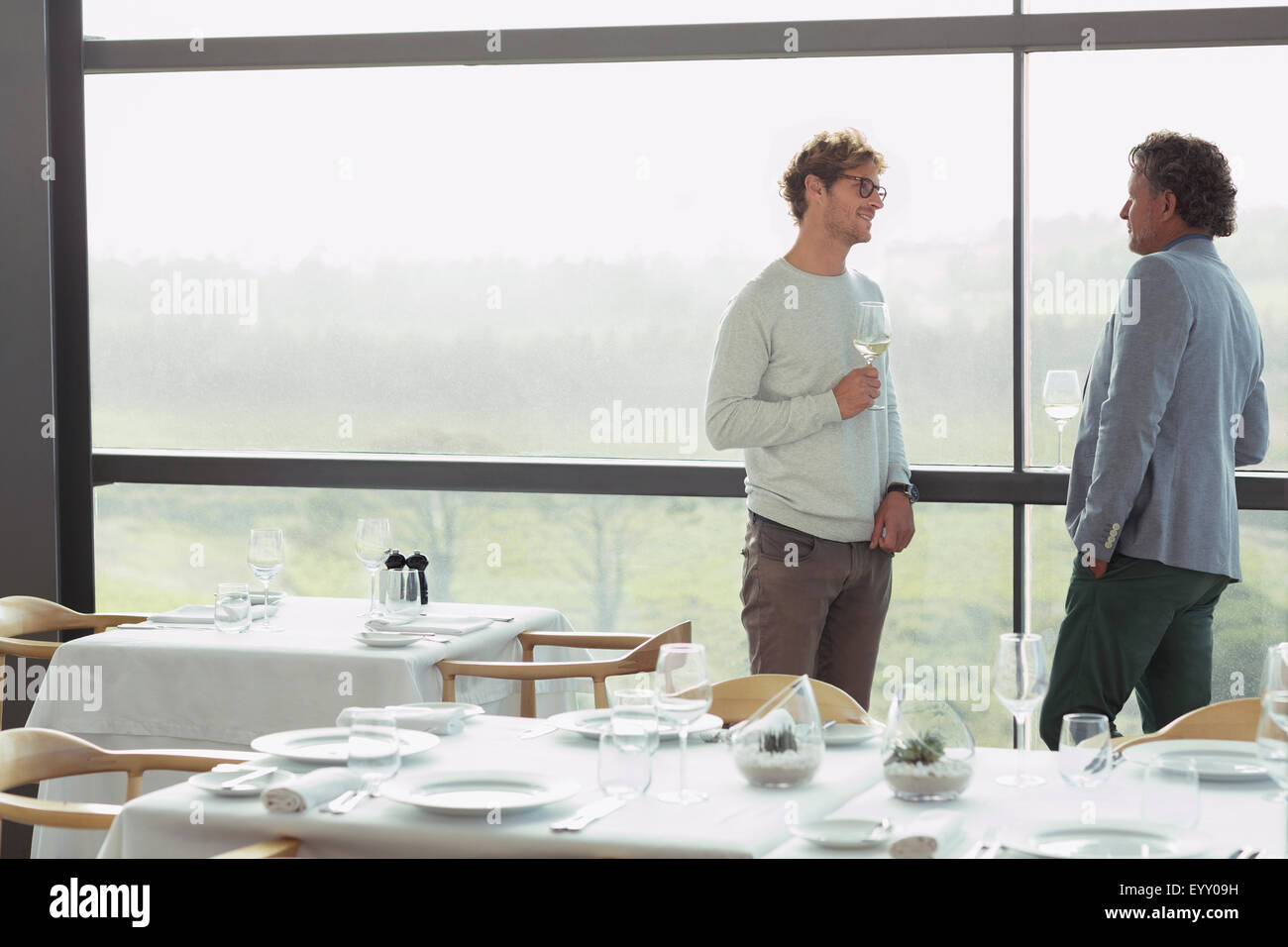 Men drinking wine at restaurant window Stock Photo - Alamy