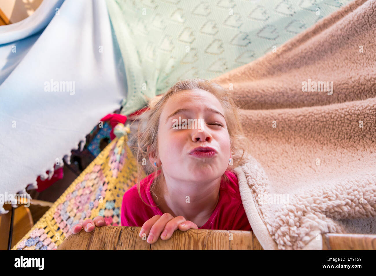 Caucasian girl playing in blanket fort Stock Photo Alamy