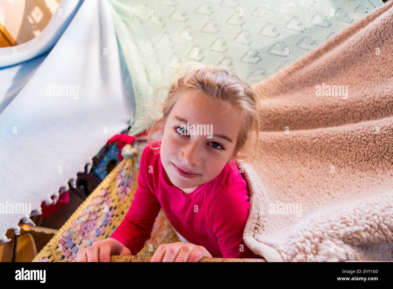 Caucasian girl playing in blanket fort Stock Photo Alamy