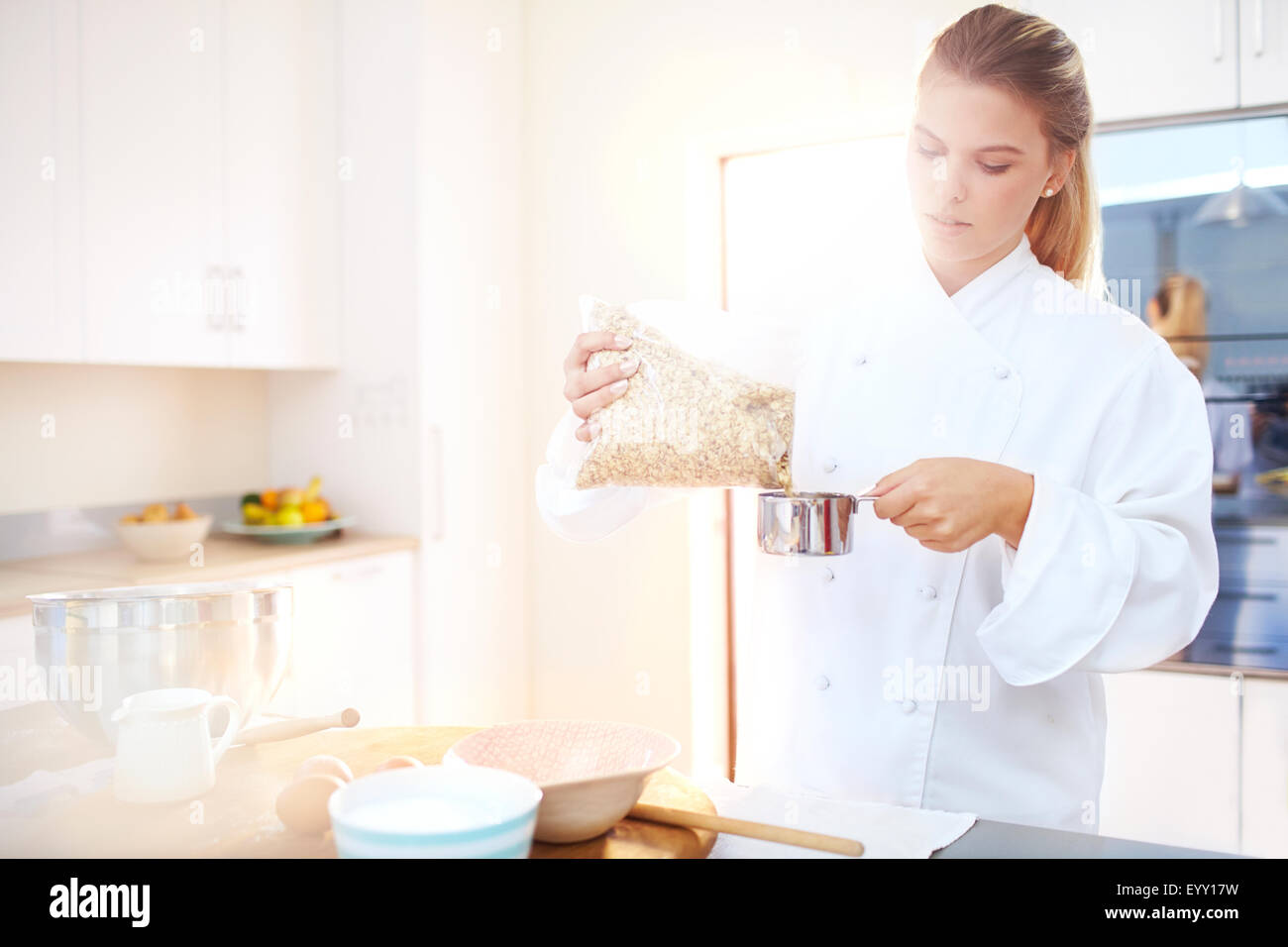 Pastry chef measuring the temperature of the chocolate with an infrared  thermometer, working on the tempering of the chocolate Stock Photo - Alamy