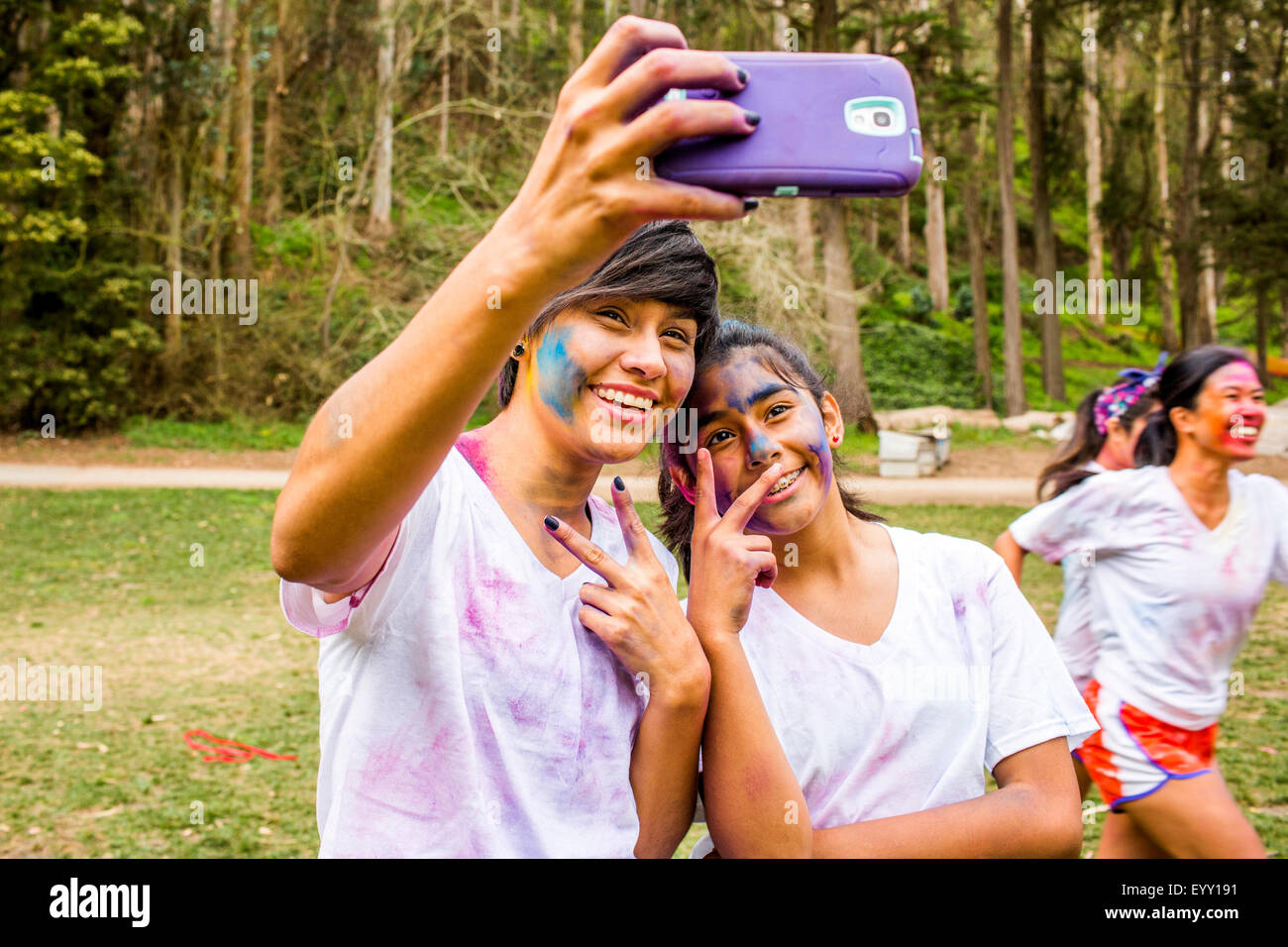 Friends taking selfie covered in pigment powder Stock Photo