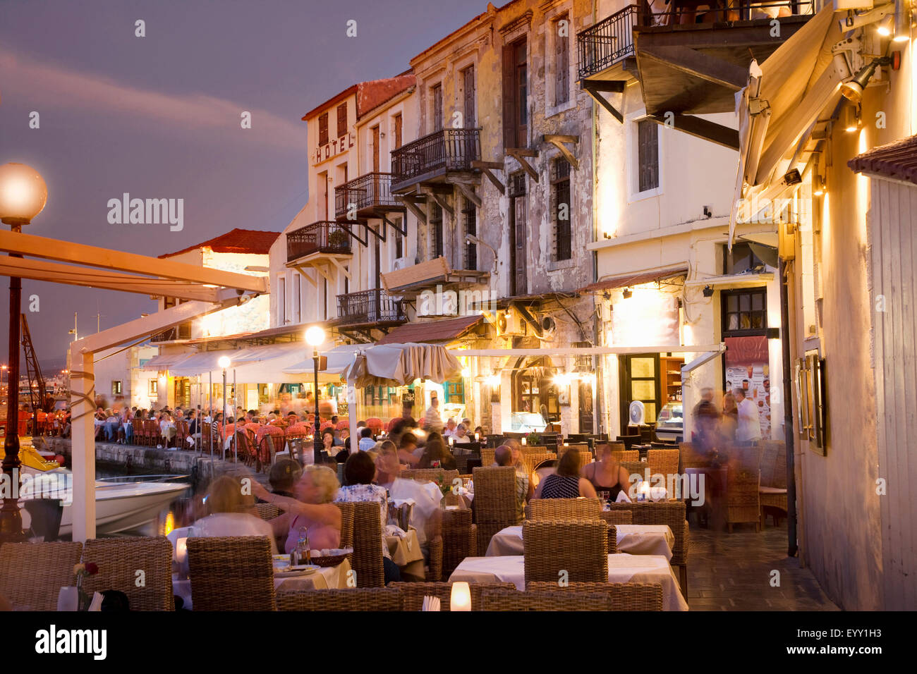 Time lapse view of sidewalk cafe at sunset, Mykonos, Cyclades, Greece Stock Photo
