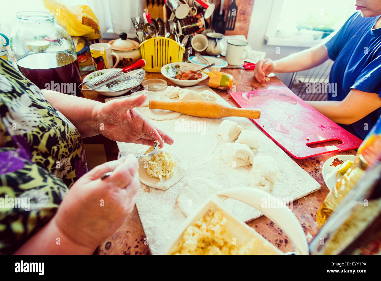 Caucasian mother and daughter cooking in kitchen Stock Photo